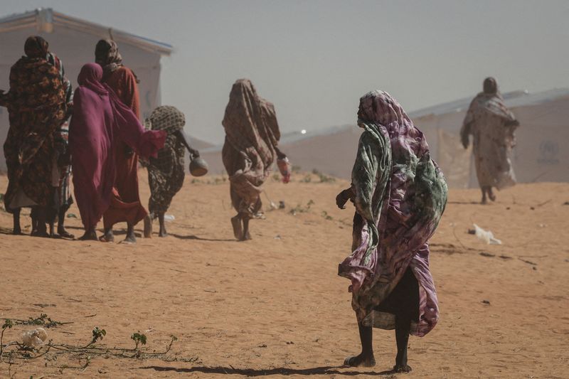 FILE PHOTO: Sudanese refugee women walk at the Tulum refugee camp, amid ongoing conflict in Sudan between the paramilitary Rapid Support Forces (RSF) and the Sudanese army, in Wadi Fira province, eastern Chad, November 30, 2025. REUTERS/Amr Abdallah Dalsh/File Photo