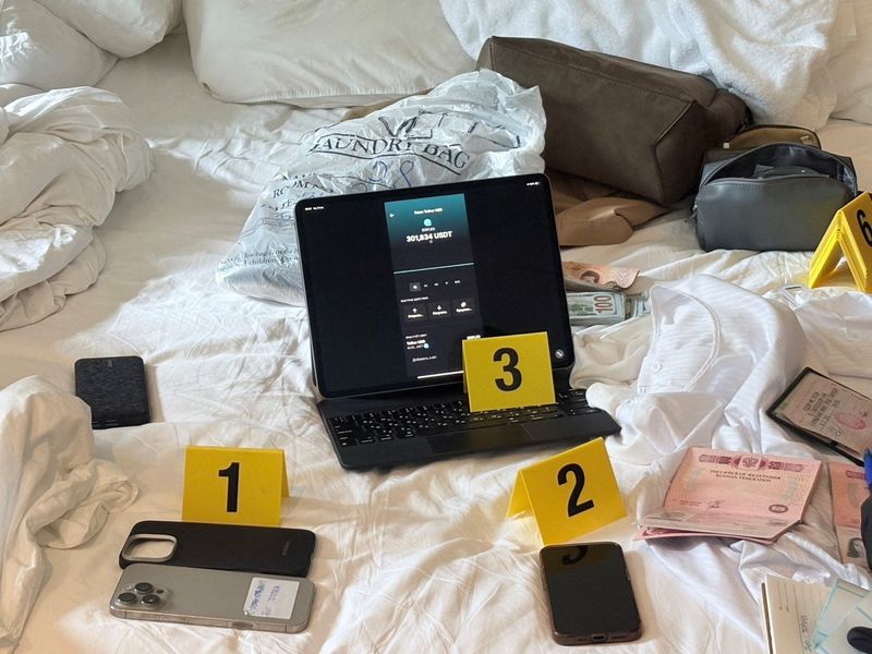 Evidence related to a Russian man, Denis Obrezko, lies on a bed in Phuket, Thailand, November 12, 2025. U.S. prosecutors say Denis Obrezko previously worked for Russia's FSB intelligence agency. Thailand's Cyber Crime Investigation Bureau/Handout via REUTERS