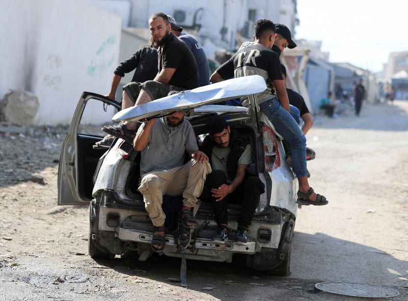 Mourners sit inside and atop a damaged car during the funeral of three Palestinians, who were killed in an Israeli strike, according to medics, in Gaza City, July 16, 2026. REUTERS/Dawoud Abu Alkas