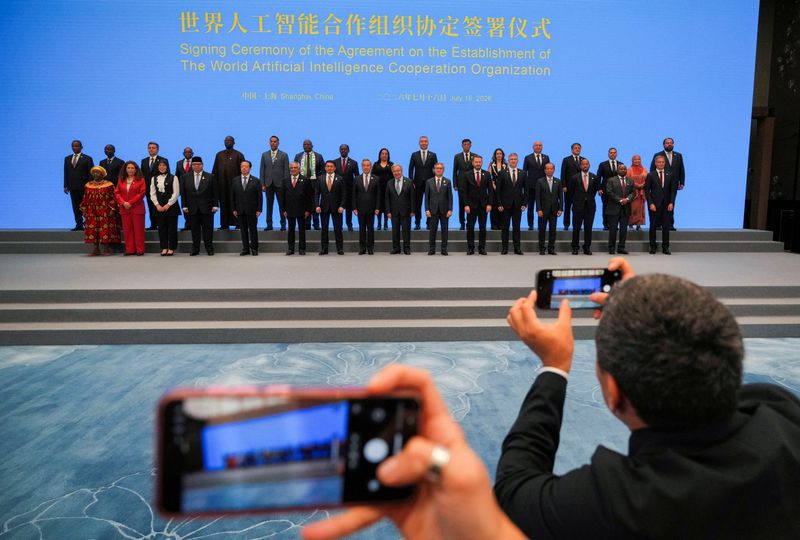 Signatories including Chinese Foreign Minster Wang Yi, pose for photos with UN Secretary-General Antonio Guterres after the signing ceremony of the Agreement on the Establishment of The World Artificial Intelligence Cooperation Organization ahead of the World AI Conference in Shanghai, China, July 16, 2026.     Ng Han Guan/Pool via REUTERS