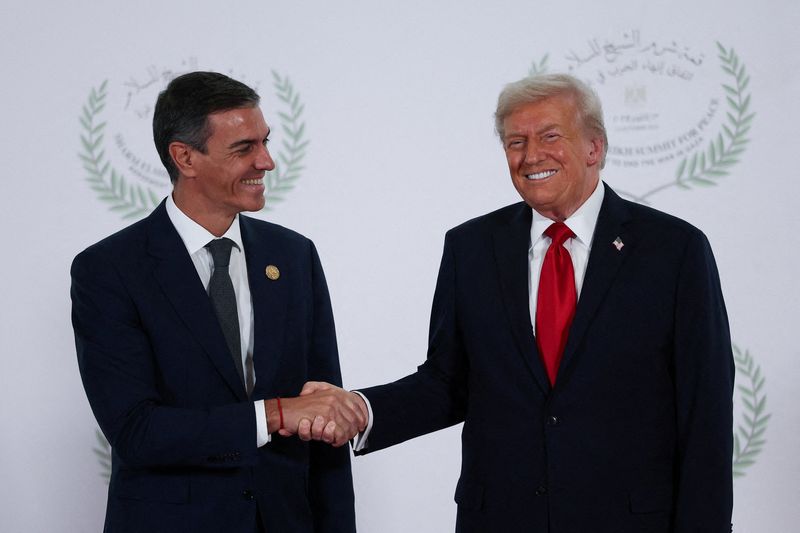 FILE PHOTO: U.S. President Donald Trump and Spanish Prime Minister Pedro Sanchez shake hands as they pose for a photo, at a world leaders' summit on ending the Gaza war, amid a U.S.-brokered prisoner-hostage swap and ceasefire deal between Israel and Hamas, in Sharm el-Sheikh, Egypt, October 13, 2025. REUTERS/Suzanne Plunkett/Pool/File Photo