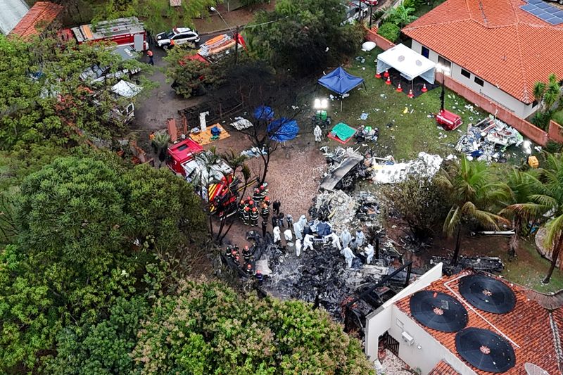 FILE PHOTO: A drone view shows people working at the site of a plane crash in Vinhedo, Sao Paulo, Brazil, August 10, 2024. REUTERS/Carla Carniel/File Photo
