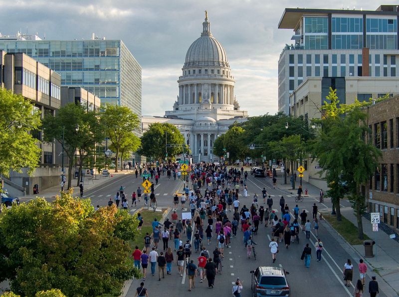 People march in protest to the Wisconsin State Capitol in response to a Madison police officer shooting and killing a man who police reported to be carrying a knife on the city's near east side, in Madison, Wisconsin July 22, 2026.   Mike De Sisti/USA Today Network via REUTERS.   NO RESALES. NO ARCHIVES. THIS IMAGE HAS BEEN SUPPLIED BY A THIRD PARTY. REFILE - CLARIFYING ATTRIBUTION