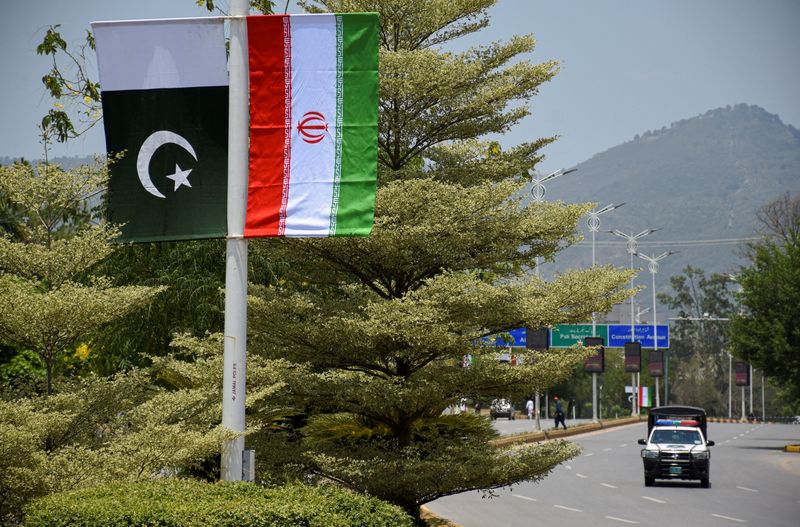 Iranian and Pakistani national flags are displayed along a street ahead of the arrival of Iran's President Masoud Pezeshkian in Islamabad, Pakistan, June 23, 2026. REUTERS/Waseem Khan