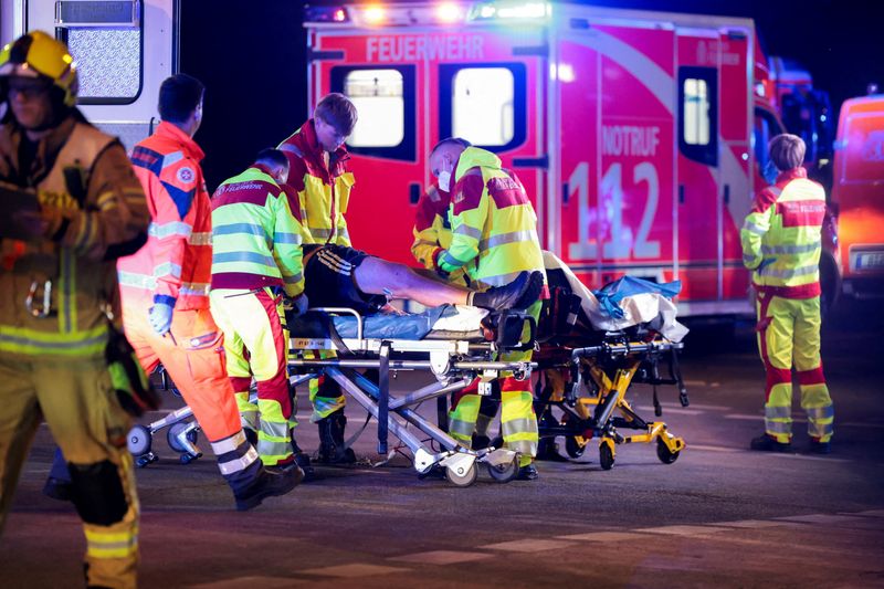 Emergency responders assist a person on a stretcher at the site, after the annual Berlin's Christopher Street Day Pride parade was called off, after a car crashed into the crowd at Tiergarten park, leaving several people injured, in Berlin, Germany, July 25, 2026.  REUTERS/Christian Mang
