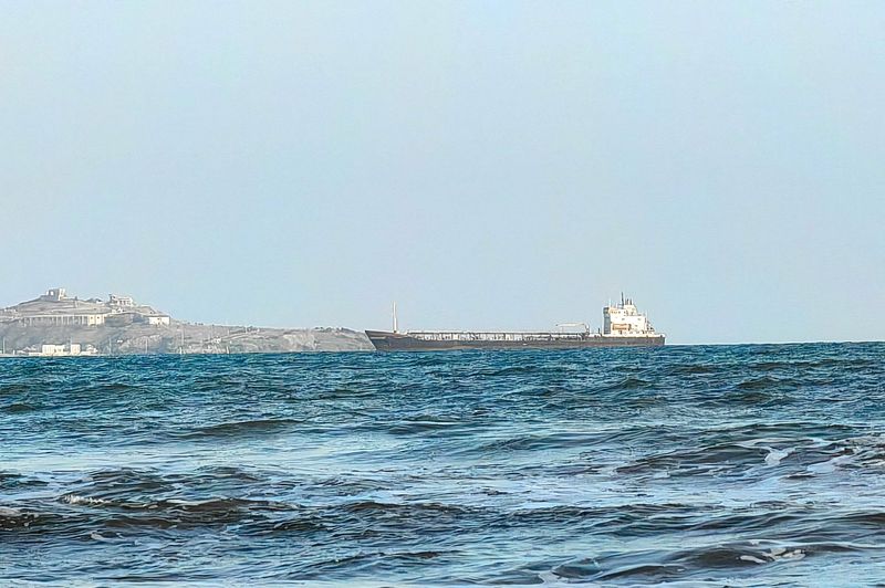 A ship off the port of Aden, where traffic remained steady after the Iran-aligned Houthis said their forces had carried out missile and drone strikes on Saudi oil tankers, in Aden, Yemen, July 23, 2026. REUTERS/Stringer