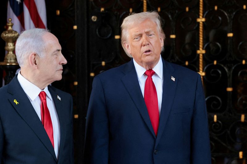 FILE PHOTO: U.S. President Donald Trump speaks next to Israeli Prime Minister Benjamin Netanyahu upon arrival for meetings at Trump's Mar-a-Lago club in Palm Beach, Florida, U.S., December 29, 2025. REUTERS/Jonathan Ernst/File Photo
