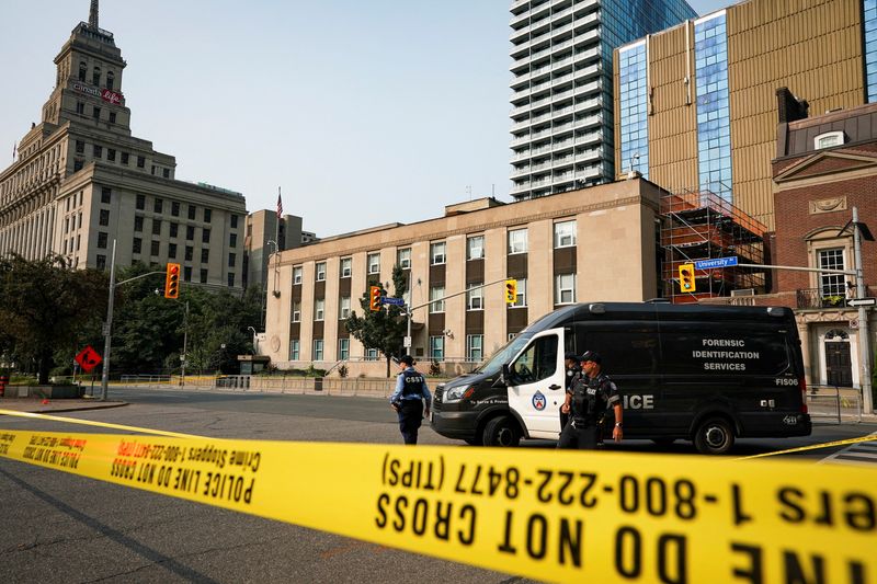 Toronto Police officers work at the scene of a shooting at the U.S. Consulate in Toronto, Ontario, Canada July 27, 2026. REUTERS/Arlyn McAdorey