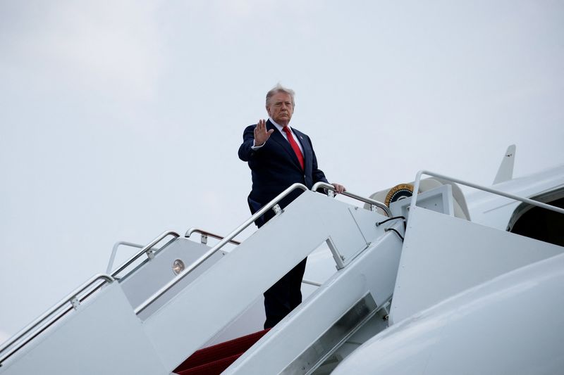 U.S. President Donald Trump gestures as he boards Air Force One en route to Michigan, at Joint Base Andrews, in Maryland, U.S., July 27, 2026. REUTERS/Evan Vucci