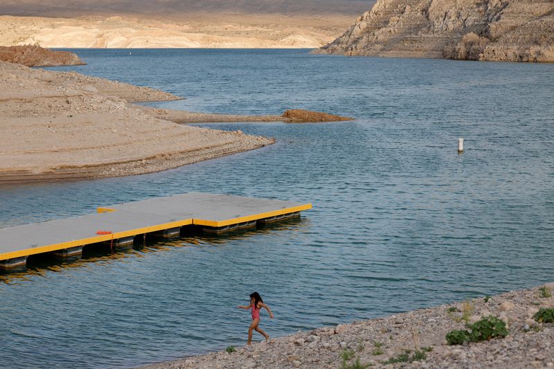 A child walks by the recently extended Echo Bay launch ramp accommodates lower water levels at Lake Mead near Overton, Nevada, U.S., July 21, 2026. Lake Mead, the largest reservoir in the United States by water capacity, has, according to the Metropolitan Water District of Southern California, declined after years of prolonged drought, rising temperatures and heavy demand on the Colorado River system as western states in the U.S. continue negotiations over future water-sharing rules. REUTERS/Caroline Brehman