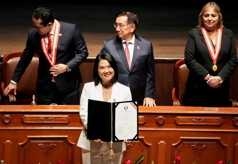 FILE PHOTO: Peru's President-elect Keiko Fujimori, flanked by Peru's Interim President, Jose Maria Balcazar and Roberto Burneo, president of the National Elections Jury (JNE), holds the official credentials she received from Burneo, following her victory in the presidential runoff after the June 7 election, in Lima, Peru, July 15, 2026. REUTERS/Angela Ponce/File Photo