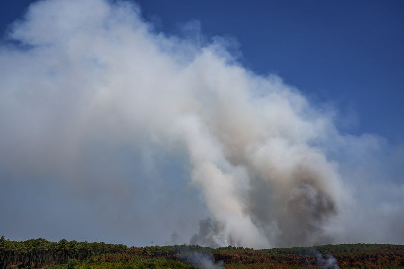 Smoke rises from a wildfire in Le Grand Crohot amid drought conditions following a heatwave and water shortages across much of France, Lege-Cap-Ferret, Gironde department, France, July 28, 2026. REUTERS/Florion Goga