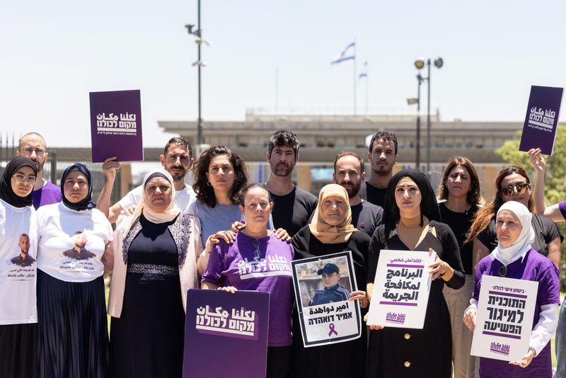 Members of the Standing Together movement, part of a new Arab-Jewish party "A Place For Us All" stand for a photograph with bereaved families of Israel's Arab community, by the Knesset, Israel's Parliament, in Jerusalem, July 13, 2026. REUTERS/Nir Elias