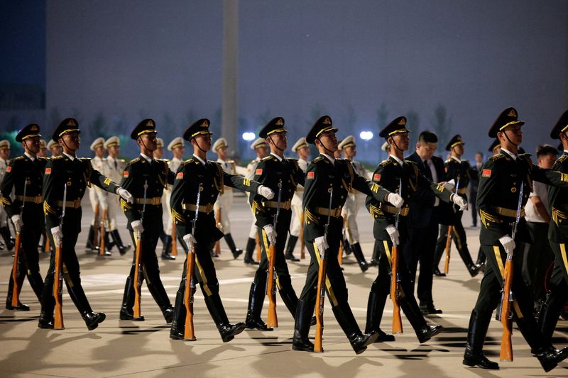 FILE PHOTO: Members of the military prepare for arrival ceremony as U.S. President Donald Trump arrives aboard Air Force One at Beijing Capital International Airport during his visit to the country, in Beijing, China, May 13, 2026. REUTERS/Evan Vucci/File Photo