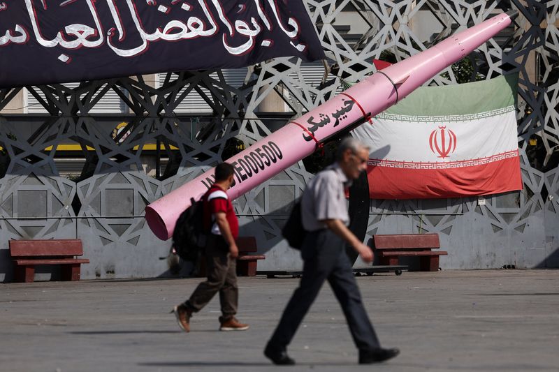 FILE PHOTO: People walk next to a symbolic mockup of an Iranian missile and an Iranian flag at Imam Hussein Square in Tehran, Iran, July 12, 2026. Majid Asgaripour/WANA (West Asia News Agency) via REUTERS/ File Photo