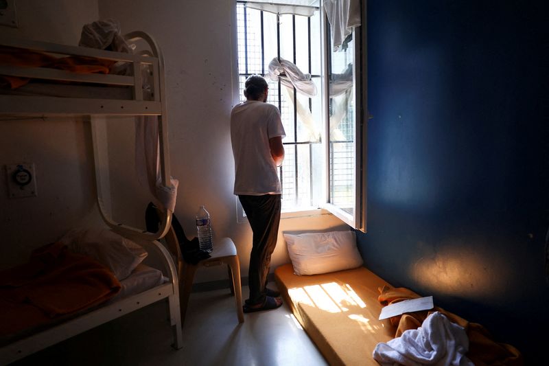 An inmate looks out the window from his prison cell as he tries to stay cool during the heatwave in Orleans, France, July 13, 2026. REUTERS/Abdul Saboor
