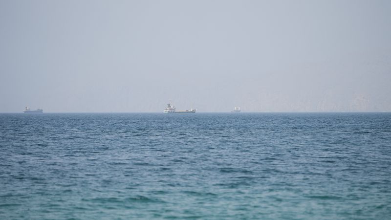 Vessels near the Strait of Hormuz, as seen from Musandam, Oman, August 6, 2026. REUTERS/Stringer