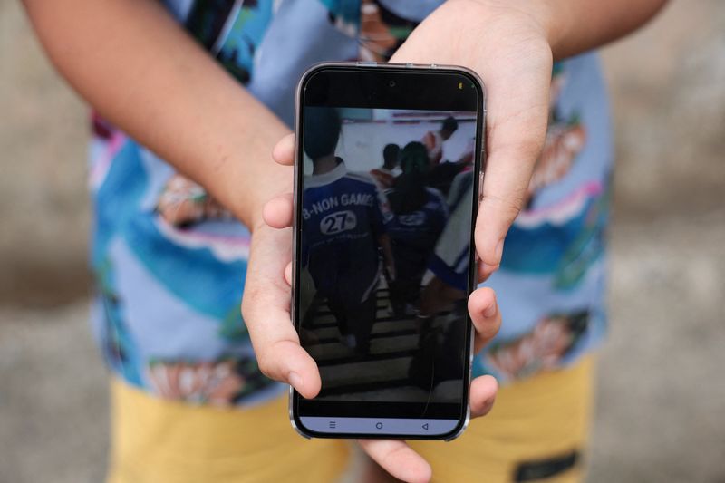 Khim, a 14-year-old eighth-grade student at Debsirin Nonthaburi School, shows footage she recorded during evacuation, during an exclusive interview with Reuters about what she saw and witnessed during the shooting incident at the school, a day after the incident, in Bang Kruai district, Nonthaburi province, on the outskirts of Bangkok, Thailand, August 8, 2026. REUTERS/Chalinee Thirasupa