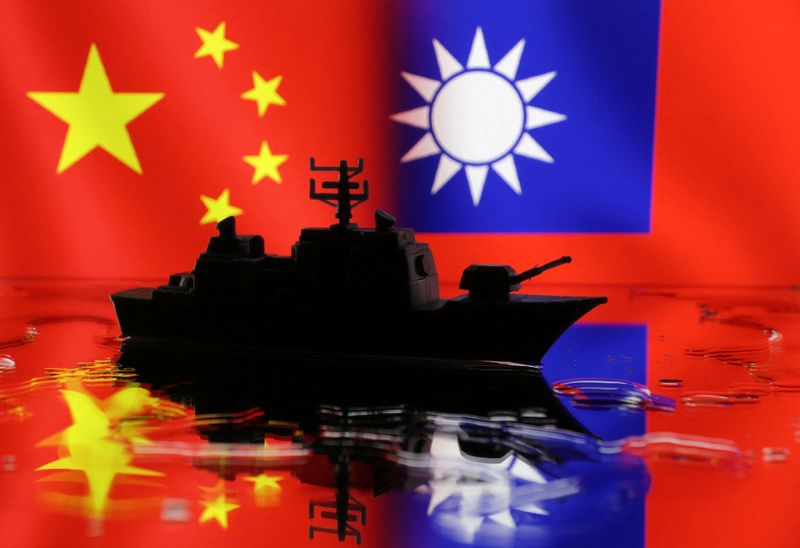 A Navy miniature is seen in front of displayed Chinese and Taiwanese flags in this illustration taken, April 11, 2023. REUTERS/Dado Ruvic/Illustration
