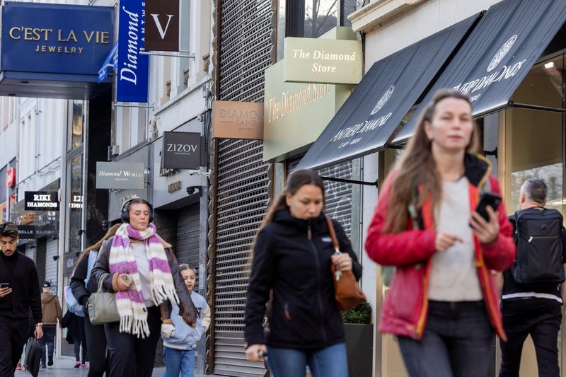 People walk past diamond shops in the city centre of Antwerp, Belgium November 7, 2025. REUTERS/Geert Vanden Wijngaert