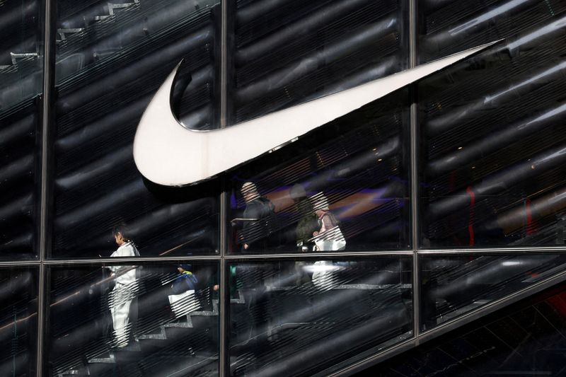 FILE PHOTO: People descend stairs inside a Nike store in New York City, U.S., April 2, 2025. REUTERS/Kylie Cooper/File Photo