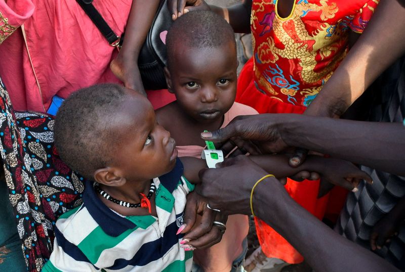 FILE PHOTO: Children are examined for malnutrition, as civilians who fled the war-torn Sudan following the outbreak of fighting between the Sudanese army and the paramilitary Rapid Support Forces (RSF) gather to register at the United Nations High Commissioner for Refugees (UNHCR) after crossing at the Joda South border point, in Renk County, Upper Nile state, South Sudan, April 30, 2023. REUTERS/Jok Solomun/File Photo