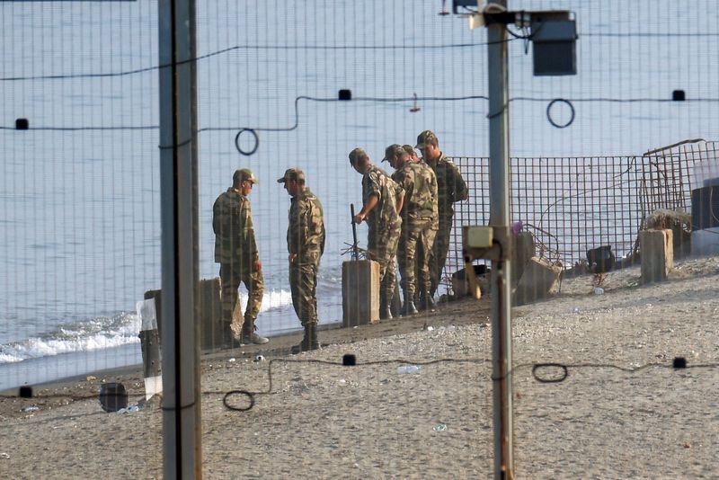 Military personnel work on the border with Morocco in Ceuta, following mass crossings of migrants on foot and by sea from Morocco into Spanish territory, in Ceuta, Spain, August 14, 2026. REUTERS/Pedro Nunes