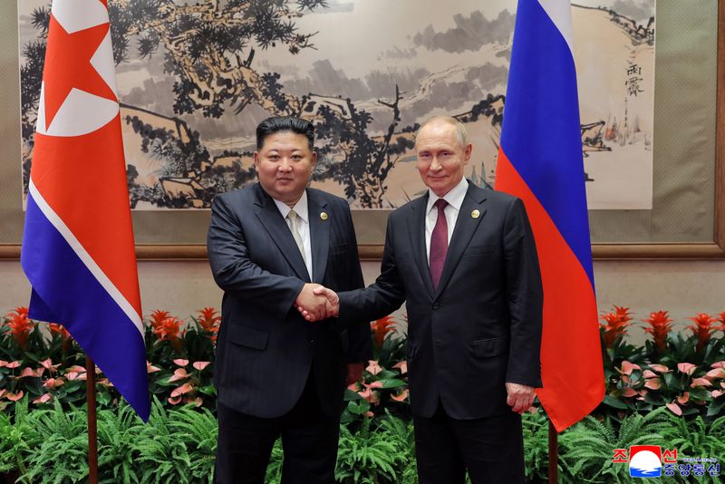 FILE PHOTO: North Korean leader Kim Jong Un shakes hands with Russian President Vladimir Putin as they attend a ceremony to mark the 80th anniversary of the end of World War Two, in Beijing, China, in this picture released by the Korean Central News Agency on September 4, 2025/File Photo
