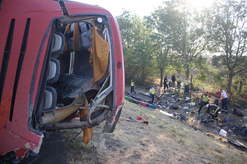 Firefighters and emergency workers at the scene of a deadly accident, where a Polish bus carrying tourists veered off the motorway and overturned, near Mezokeresztes, Hungary, in this handout image released on August 16, 2026. Balazs Toth/Mezokovesd Kepekben/Handout via REUTERS