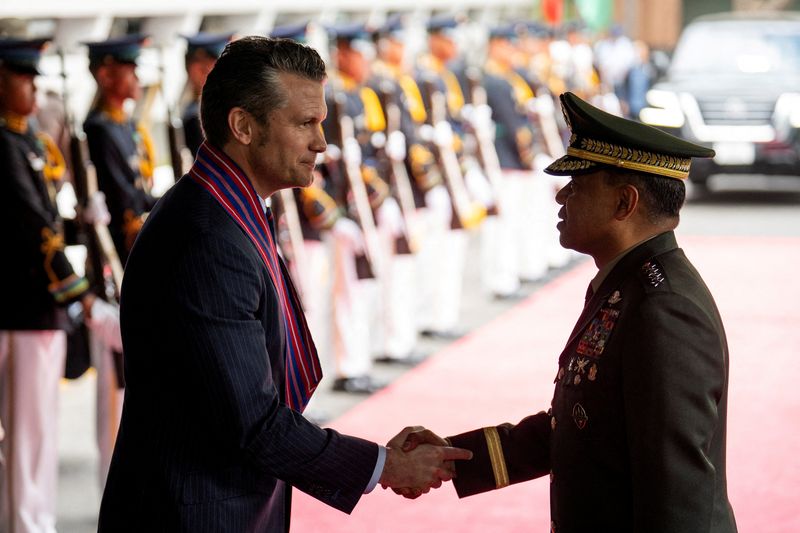 FILE PHOTO: U.S. Defense Secretary Pete Hegseth and Chief of Staff of the Armed Forces of the Philippines Romeo Brawner Jr shake hands at Camp Aguinaldo, in Quezon City, Metro Manila, Philippines, March 28, 2025. REUTERS/Lisa Marie David/File Photo