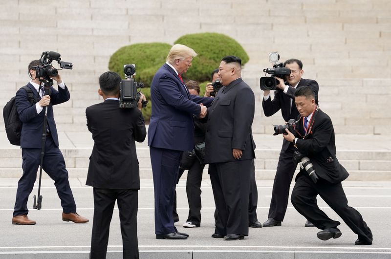 FILE PHOTO: U.S. President Donald Trump meets with North Korean leader Kim Jong Un at the demilitarized zone separating the two Koreas, in Panmunjom, South Korea, June 30, 2019. REUTERS/Kevin Lamarque/File Photo