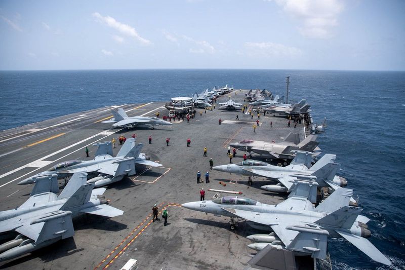 U.S. Navy sailors work on the flight deck of the aircraft carrier USS George Washington as it transits the Arabian Sea to support U.S. military operations in the war with Iran August 20, 2026. U.S. Navy/Handout via REUTERS