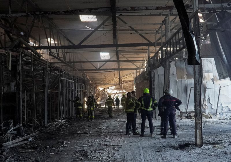 Rescuers work at the site of a shopping centre destroyed by yesterday's Russian drone attack, amid Russia's attack on Ukraine, in the city of Kryvyi Rih, Dnipropetrovsk region, Ukraine, August 22, 2026. REUTERS/Ihor Kuznietsov
