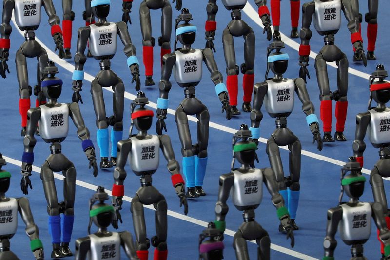 Booster Robotics humanoid robots walk in formation during the opening ceremony for the second World Humanoid Robot Games at the National Speed Skating Oval in Beijing, China August 22, 2026. REUTERS/Florence Lo