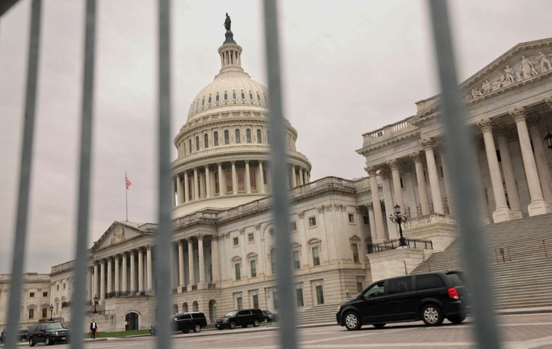 FILE PHOTO: The dome of the U.S. Capitol is seen through a security fence on Capitol Hill in Washington, U.S., December 20, 2024. REUTERS/Kevin Lamarque/File Photo