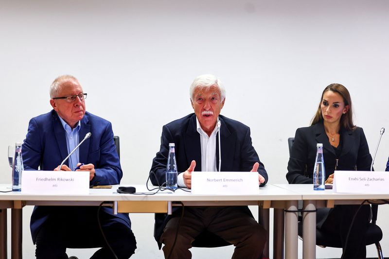 Candidate for Gelsenkirchen mayor from Germany's far-right Alternative for Germany (AfD) party Norbert Emmerich; Friedhelm Rikowski and Enxhi Seli-Zacharias of AfD react to the  exit polls for the North Rhine-Westphalian (NRW) local elections, in Gelsenkirchen, Germany, September 14, 2025. REUTERS/Leon Kuegeler