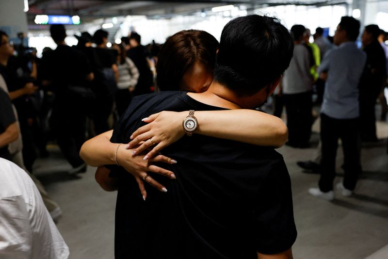 A South Korean worker who was detained in a huge immigration raid last week at the site of a U.S. car battery project involving Hyundai Motor and LG Energy Solution in the U.S. state of Georgia, hugs a family member in the long term parking lot at the Incheon International Airport in Incheon, South Korea, September 12, 2025. REUTERS/Kim Soo-hyeon/File Photo