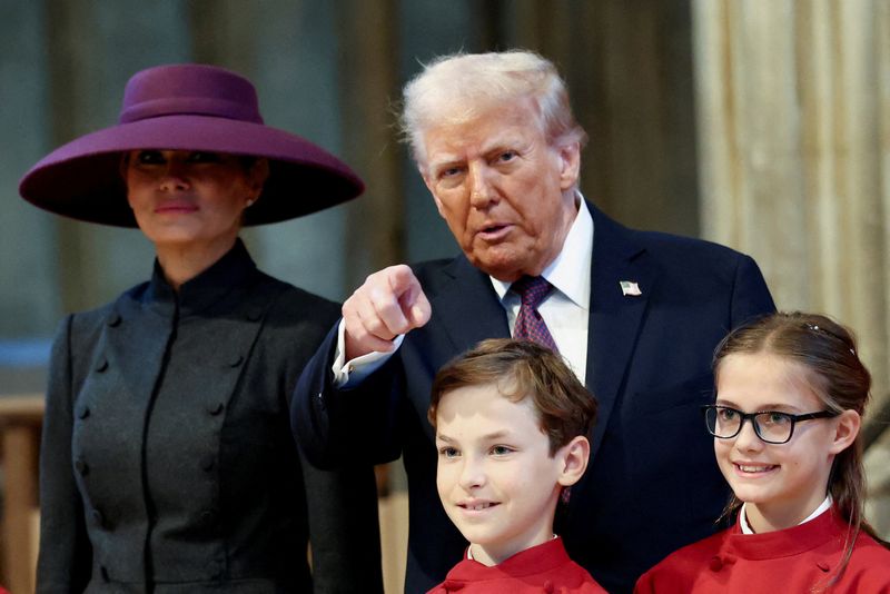 U.S. President Donald Trump points a finger as he and first lady Melania Trump visit St. George's Chapel during their state visit in Windsor, Britain, September 17, 2025. REUTERS/Kevin Lamarque
