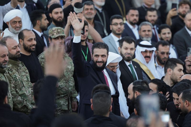 FILE PHOTO: Syria’s interim President Ahmed al-Sharaa waves as he attends the “Aleppo, Key to Victory” celebration marking Syria’s liberation, in Aleppo, Syria May 27, 2025. REUTERS/Khalil Ashawi/File Photo