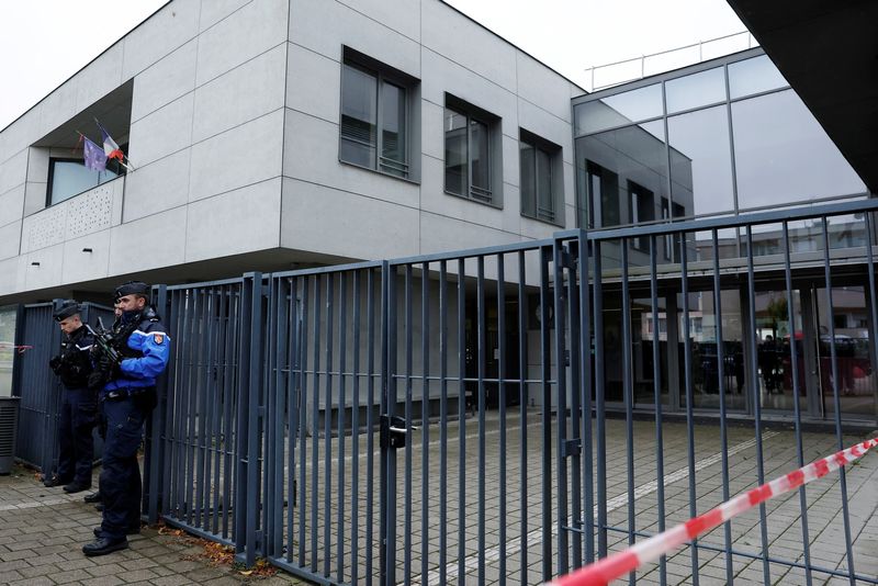 French gendarmes stand in front of the College Robert Schuman secondary school where a teacher was stabbed in class by a 14-year-old student, in Benfeld, near Strasbourg, France, September 24, 2025. REUTERS/Stephanie Lecocq