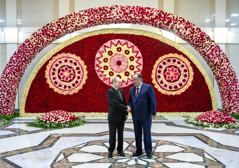 Russian President Vladimir Putin shakes hands with Tajik President Emomali Rahmon during a meeting in Dushanbe, Tajikistan October 8, 2025. Sputnik/Grigory Sysoev/Pool via REUTERS