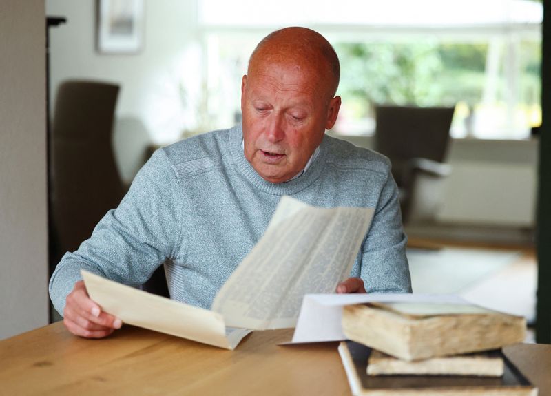 Paul Post, a retired Dutch systems specialist, looks at the war-time diaries of his father, who described working in the Netherlands' diamond bureau during the Nazi occupation, in Driehuis, Netherlands October 6, 2025. REUTERS/Piroschka van de Wouw