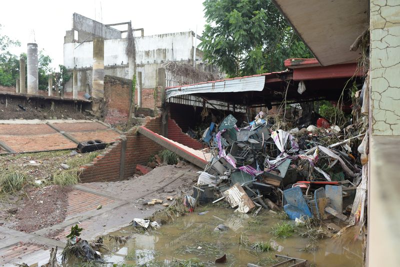 Stacked school desks at a damaged school after torrential rains that overflowed rivers, causing flooding in Poza Rica, Veracruz state, Mexico October 11, 2025. REUTERS/Rolando Ramos