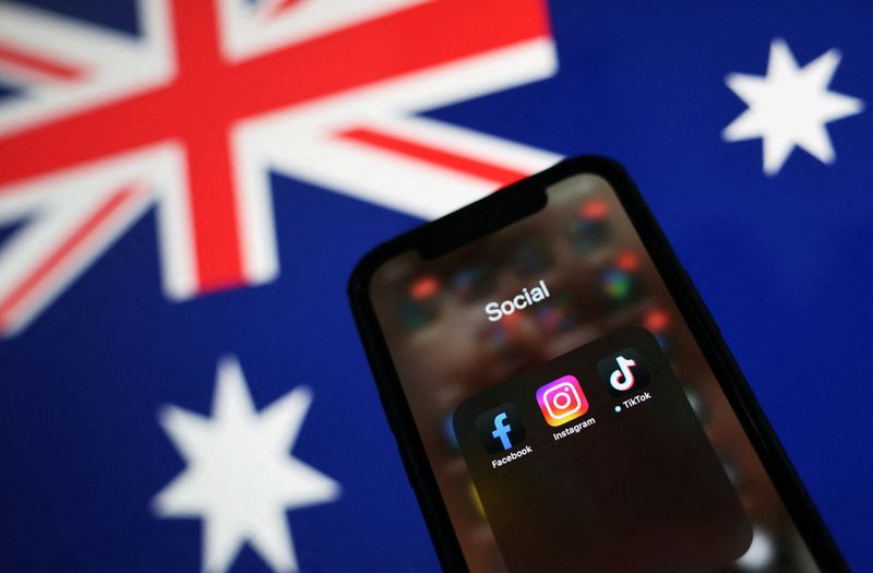 Facebook, Instagram and TikTok apps are seen on a smartphone in front of an Australian flag, in this illustration taken November 29, 2024. REUTERS/Edgar Su/Illustration