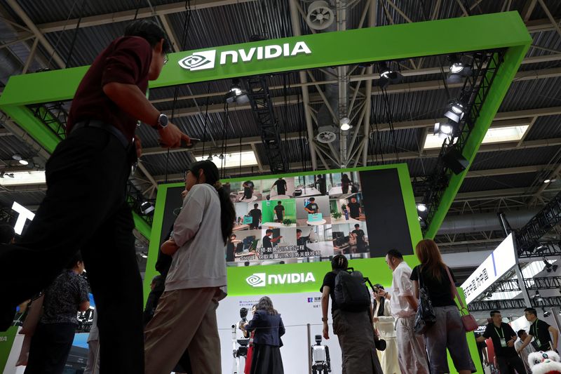 People walk past the Nvidia booth during the China International Supply Chain Expo in Beijing, China July 16, 2025. REUTERS/Florence Lo