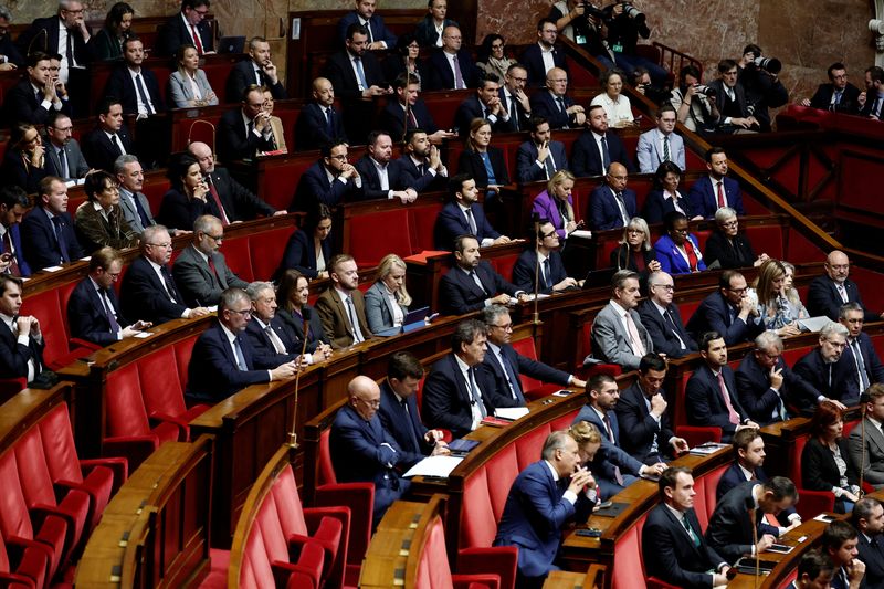 Members of parliament of French far-right National Rally (Rassemblement National - RN) party parliamentary group, and the Union des Droites (UDR) parliamentary group, attend a debate before votes on two no-confidence motions against the French government tabled by members of parliament of La France Insoumise (France Unbowed - LFI) and the Rassemblement National (National Rally - RN), two days after the French Prime Minister's general policy speech, during a public session at the National Assembly in Paris, France, October 16, 2025. REUTERS/Benoit Tessier