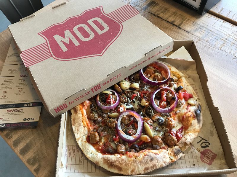 Mod Pizza's gas-fired ovens cook pizzas within a matter of minutes.