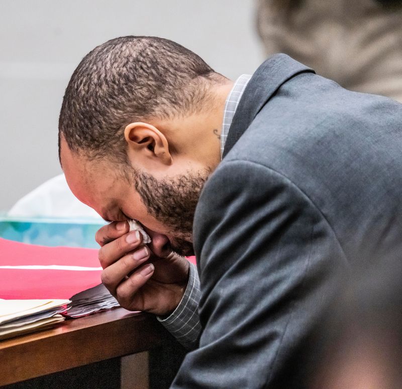 Defendant Darrell Brooks wipes away tears as he makes his opening statement to the jury in a Waukesha County Circuit Court in Waukesha Thursday Brooks, who is representing himself during the trial, is charged with driving into a Waukesha Christmas Parade last year, killing six people and injuring dozens more.