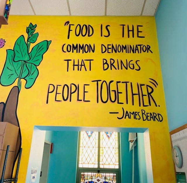 A bright mural greets people as they walk through the main doors of the Grow It Forward building.