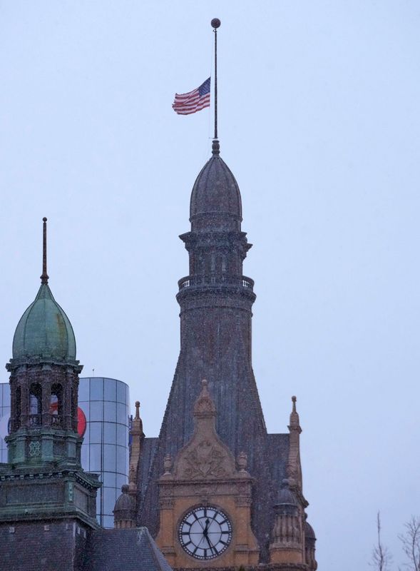 The American Flag flies at half staff at Milwaukee City Hall in Milwaukee on Thursday, Dec. 22, 2022. Gov. Tony Evers has ordered the American and Wisconsin flags to be flown at half-staff Thursday in honor of Aundre Cross, the U.S. Postal Service mail carrier who was shot and killed Dec. 9.